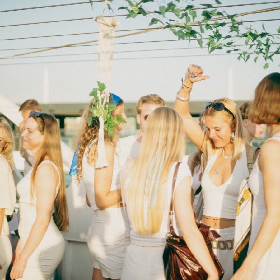 Guests dancing on deck at golden hour